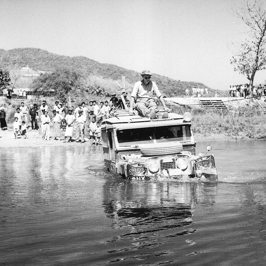 A LandRover drives through a river - Oxcam Expedition far east 1955